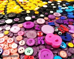 A group of colorful buttons arranged on a table.