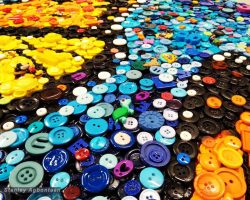 A large pile of colorful buttons on a table for installation in a School in Washington DC.