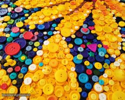 A colorful flower made of mosaic buttons by a DC Artist.