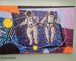 A mosaic painting of two astronauts on a school wall in Washington DC.